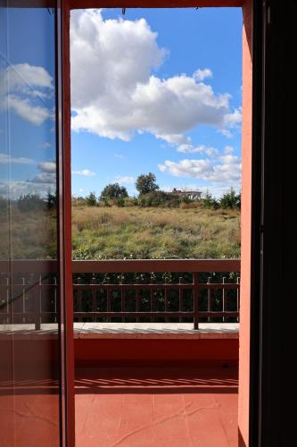 a window view of a field from a balcony at El Cedre Blau Vivienda con piscina en Granollers in Granollers
