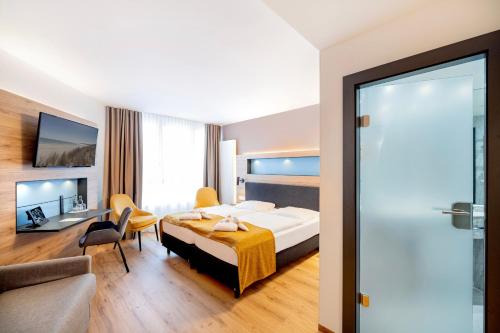a hotel room with a bed and a couch at Parkhotel Rügen in Bergen auf Rügen