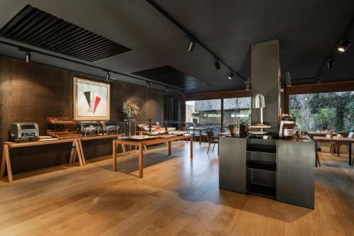 a kitchen and dining room with tables and chairs at Eurostars Pamplona in Pamplona