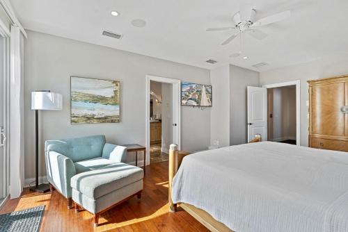 a bedroom with a bed and a chair and a ceiling fan at Oceanview Family & Pet-Friendly Escape, 300 Steps to Beach, 2608H in New Smyrna Beach