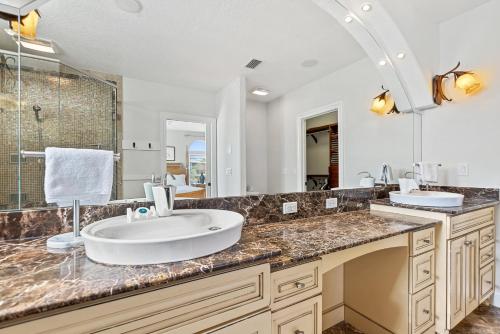 a bathroom with a sink and a large mirror at Oceanview Family & Pet-Friendly Escape, 300 Steps to Beach, 2608H in New Smyrna Beach