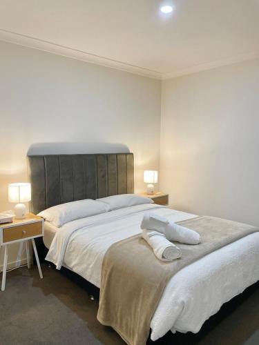 a bedroom with a large bed with two pillows on it at Cloverton Escape Retreat in Kalkallo