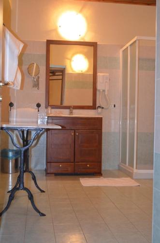 a bathroom with a sink and a mirror at Hotel Julia in Cassano dʼAdda