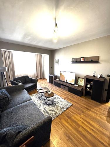 Una sala de estar con un sofá y un televisor de pantalla plana. en Frankie apartment, en Varna