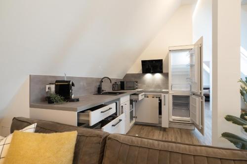 a kitchen with a couch in a living room at Luxury Apartment im Luftkurort Tengen in Tengen