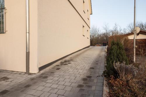 a sidewalk next to a building with dog footprints on it at Luxury Apartment im Luftkurort Tengen in Tengen