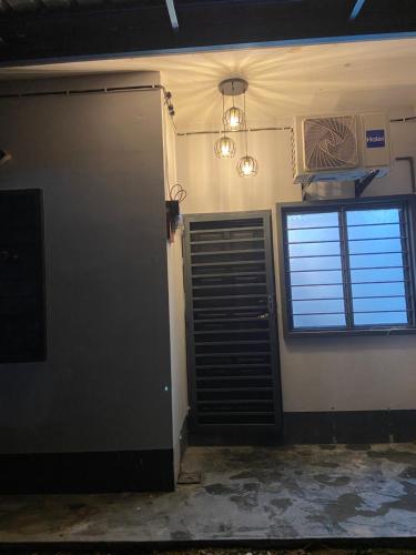 an empty room with a door and a window at homestay d klebang besar in Kelebang Besar