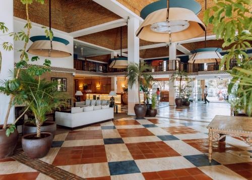 a lobby with a checkered floor and potted plants at Grande Real Santa Eulalia Resort & Hotel Spa in Albufeira