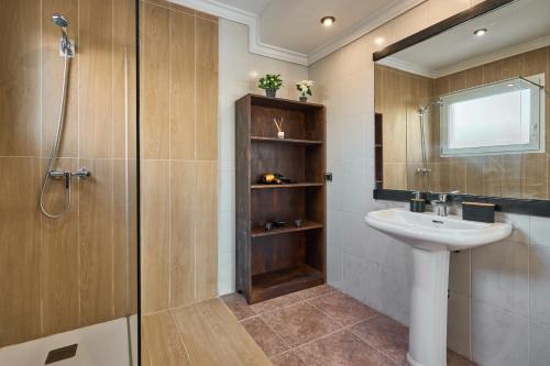 a bathroom with a sink and a shower at Villa Martin in Portocolom
