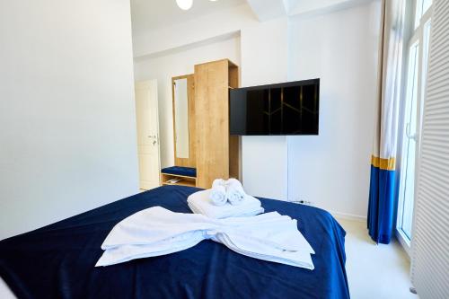 a room with a bed with towels on it at Carol Park View in Bucharest