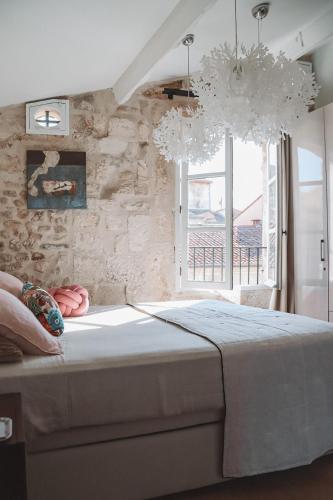 une chambre avec un grand lit et une fenêtre dans l'établissement Luxury Town House Centre Arles, à Arles