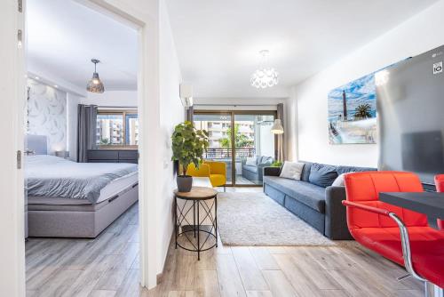 a bedroom and living room with a bed and a couch at Luxury Pool View Apartment Iguazu in Playa del Ingles