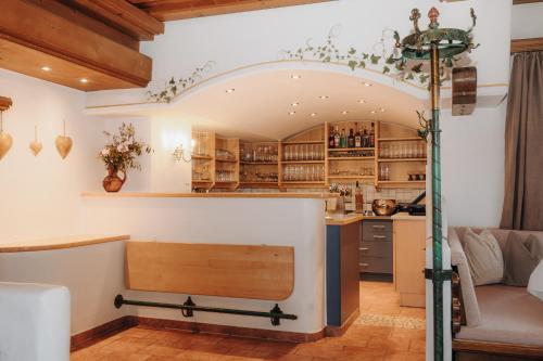 a kitchen and living room with a table and a couch at Hotel Krone Großarl in Grossarl