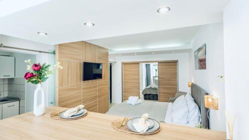 a dining table with a vase of flowers on top of it at Studio Kronstadt - Gara Brașov in Braşov