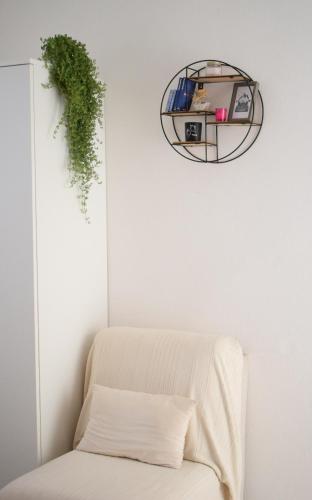 a room with a white couch and a mirror at La Casa del Carrubo in Cagliari
