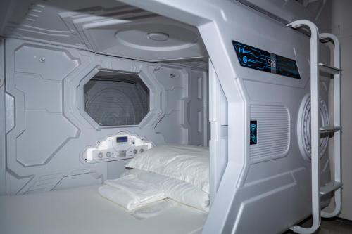 an inside view of a hospital room with a bed at Kiwi Capsule Hotel in Bangkok