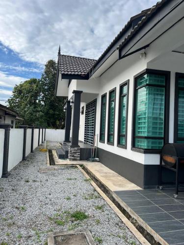 a white house with a pathway leading to it at Syakila Homestay in Marang