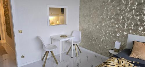 a room with two chairs and a table and a mirror at Let's RelaxX Luxury class in Mülheim an der Ruhr