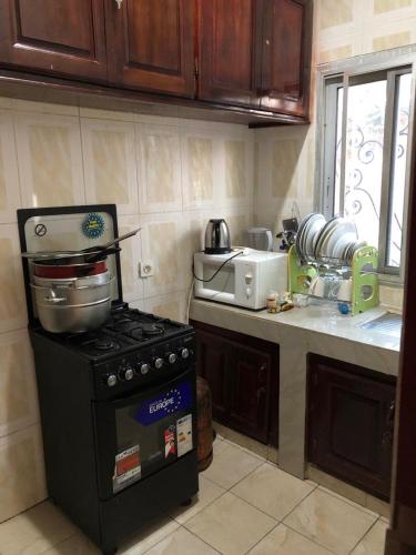 a kitchen with a stove and a sink at général in Yaoundé