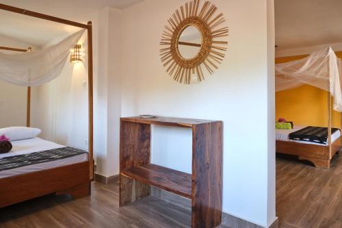 a bedroom with a bed and a mirror at Chambre double vue mer in Mar Lodj