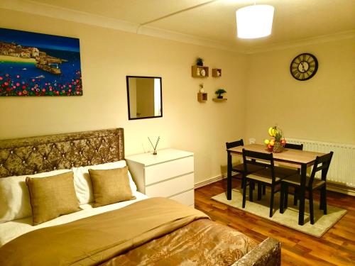 a bedroom with a bed and a dining room table at Heart of Telford Stylish 2-Bedroom in Telford