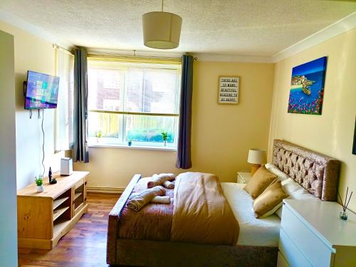 a small bedroom with a bed and a window at Heart of Telford Stylish 2-Bedroom in Telford