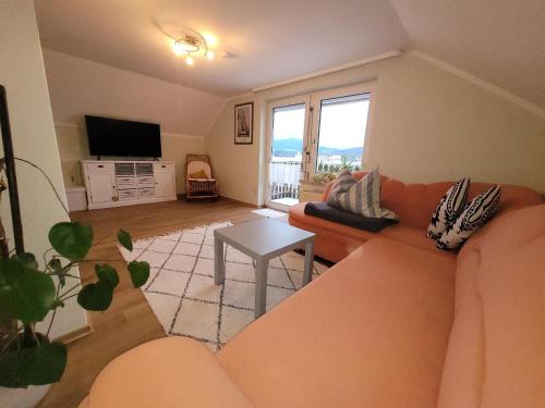 a living room with a couch and a table at Ferienwohnung Macht in Furth im Wald