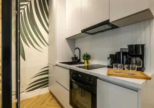 a kitchen with a sink and a counter top at AIASTAY Bucharest River Apartments in Bucharest