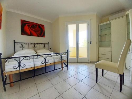 a bedroom with a bed and a chair at Maria in Caleri