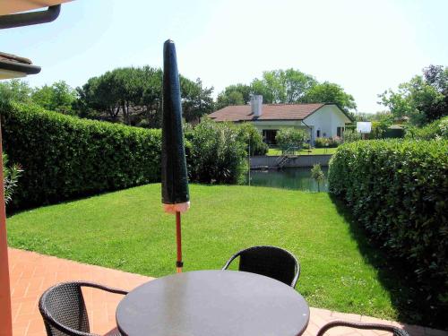 a table and chairs with a umbrella on top of it at Corallo in Caleri