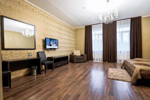 a living room with a bed and a desk at Hotel Verhovina in Kyiv