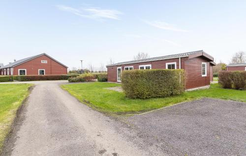 an empty road in front of a house at 2 Bedroom Cozy Home In Wagenborgen in Wagenborgen