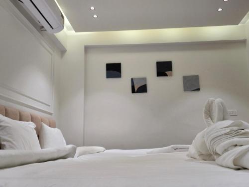 a bedroom with a bed with four pictures on the wall at Hotel Vilaasitaa inn Ujjain in Ujjain