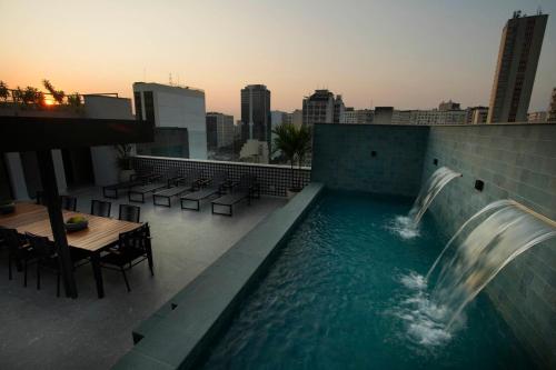 a swimming pool with a waterfall on the roof of a building at Lobie Dias Downtown in Rio de Janeiro