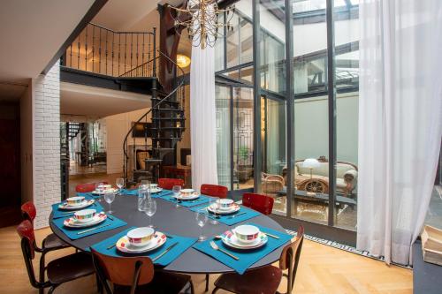 une salle à manger avec une table et des chaises bleues dans l'établissement Parisian loft with plenty of light and solarium in Bastille area, à Paris