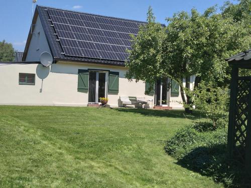 a house with solar panels on the roof at Dom wakacyjny nad jeziorem Zajączkowskim in Pniewy