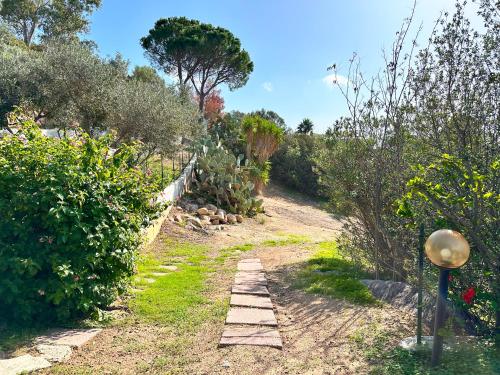 a garden with a path and some bushes at Patio on the Simius beach in Simius