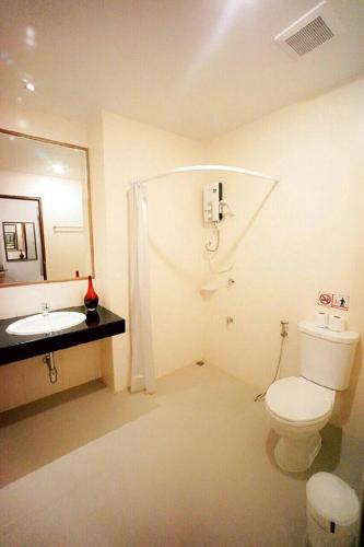 a bathroom with a toilet and a sink at Donchan Residence in Chiang Mai
