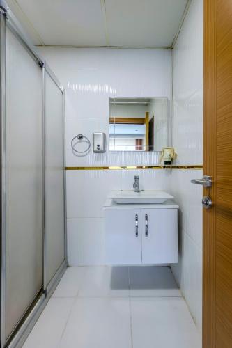 a white bathroom with a sink and a shower at EViM HOTEL ÇORLU in Çorlu