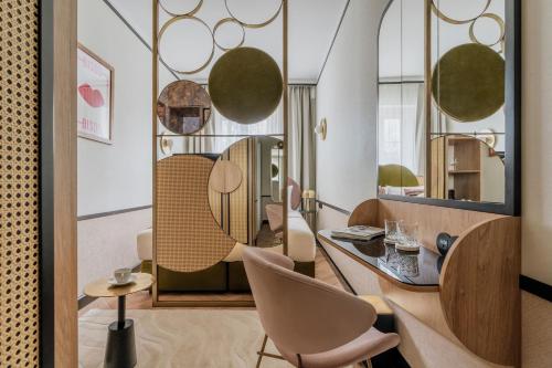 a room with a table and chairs and a mirror at Colette - LoftAffair Collection in Warsaw
