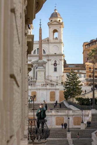 a man standing on a bike in front of a building at The Inn at the Spanish Steps Luxury Collection - The Inn at the Spanish Steps in Rome