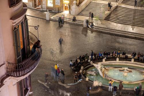 a group of people walking around a building at The Inn at the Spanish Steps Luxury Collection - The Inn at the Spanish Steps in Rome