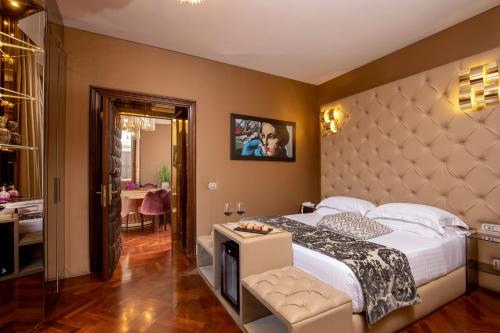 a bedroom with a large bed with a large headboard at The Inn at the Spanish Steps Luxury Collection - The Inn at the Spanish Steps in Rome