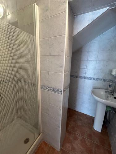 a bathroom with a shower and a sink at Casita Maite in Ardales
