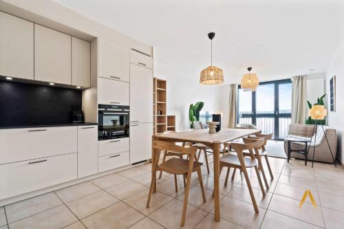 a kitchen and dining room with a table and chairs at A Stylish Retreat in Esch Urban Landscape in Esch-sur-Alzette