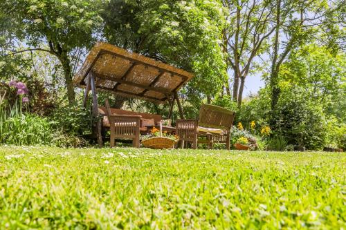 a group of chairs and a table in a garden at House Mikin Dol in Draž
