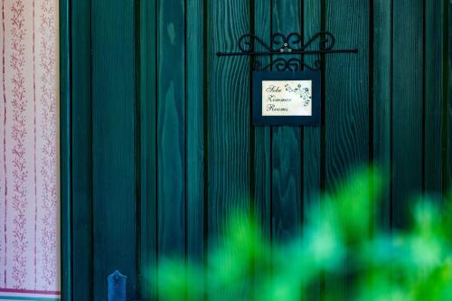 a green wall with a sign on it at House Mikin Dol in Draž