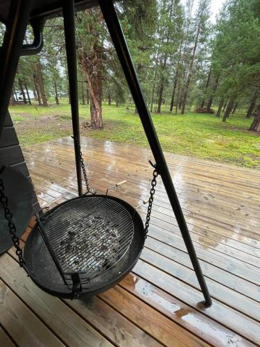 a swing on a porch in the rain at MIDGARD LODGE - Pre-Heated with Ready Beds at Bjorli in Bjorli