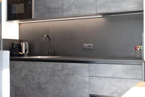 a kitchen with a sink and a microwave at Chalet-Suite Panorama in Selva dei Molini