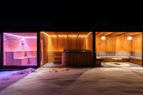 a room with wooden walls and a table and a bench at Willa Podhalanka Jacuzzi & sauna - drewniany dom dla 20 osób in Biały Dunajec